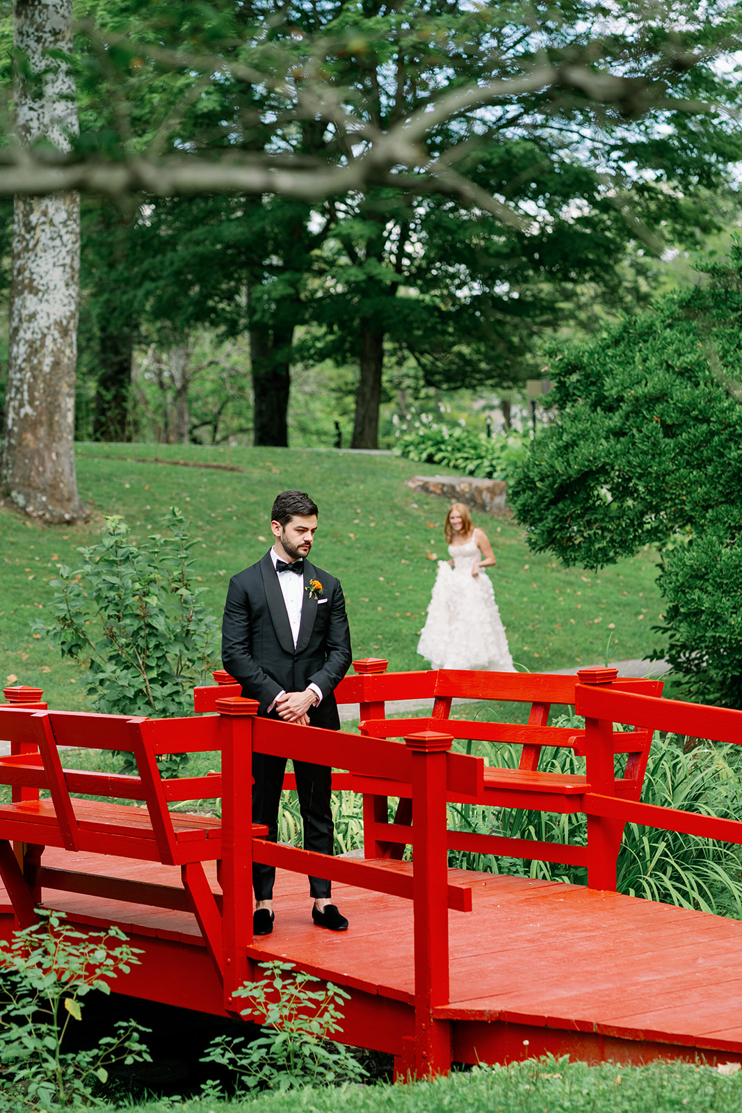 Bride and groom first look on the red bridge at Troutbeck.