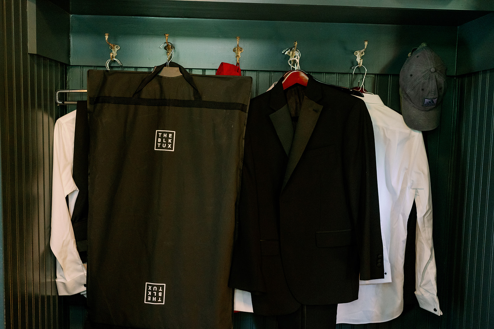 Groom's attire hanging on a coat rack in the Benton House at Troutbeck. 