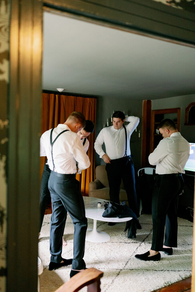 Groomsmen getting ready in the Benton House at Troutbeck. 