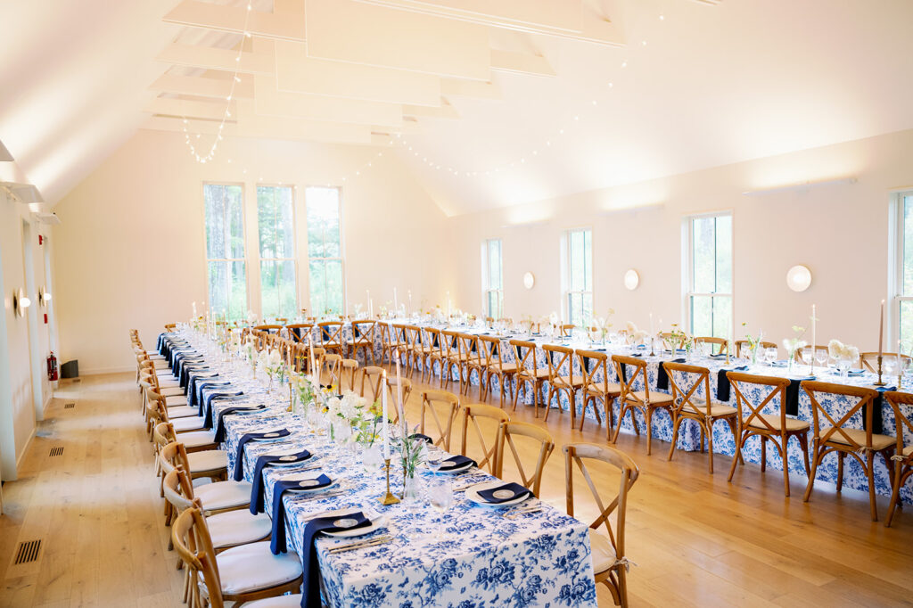 Rehearsal dinner at Troutbeck with long tables and wooden cross-back chairs.