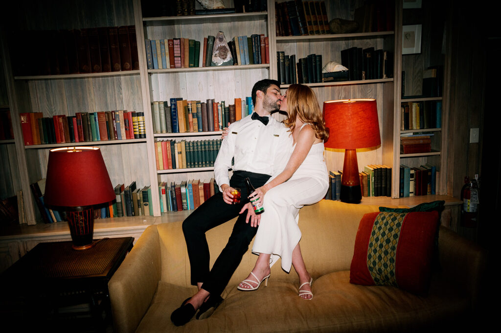 Bride and groom flash photos in the Troutbeck library.