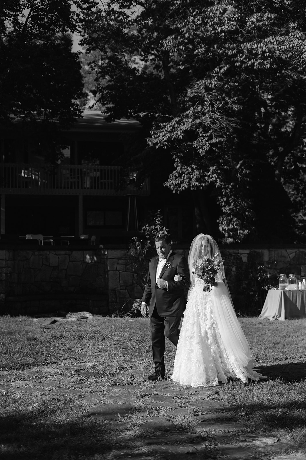 Bride and her father walking down the aisle at Troutbeck's Walled Garden.