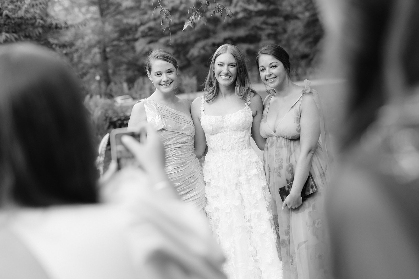 Bride and guests taking an Iphone photo.