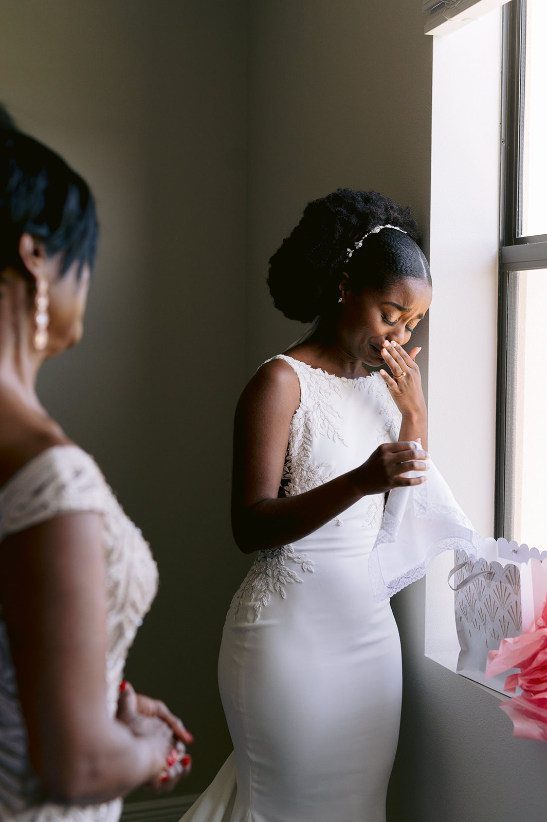 Bride getting emotional at a handmade gift from her mom.