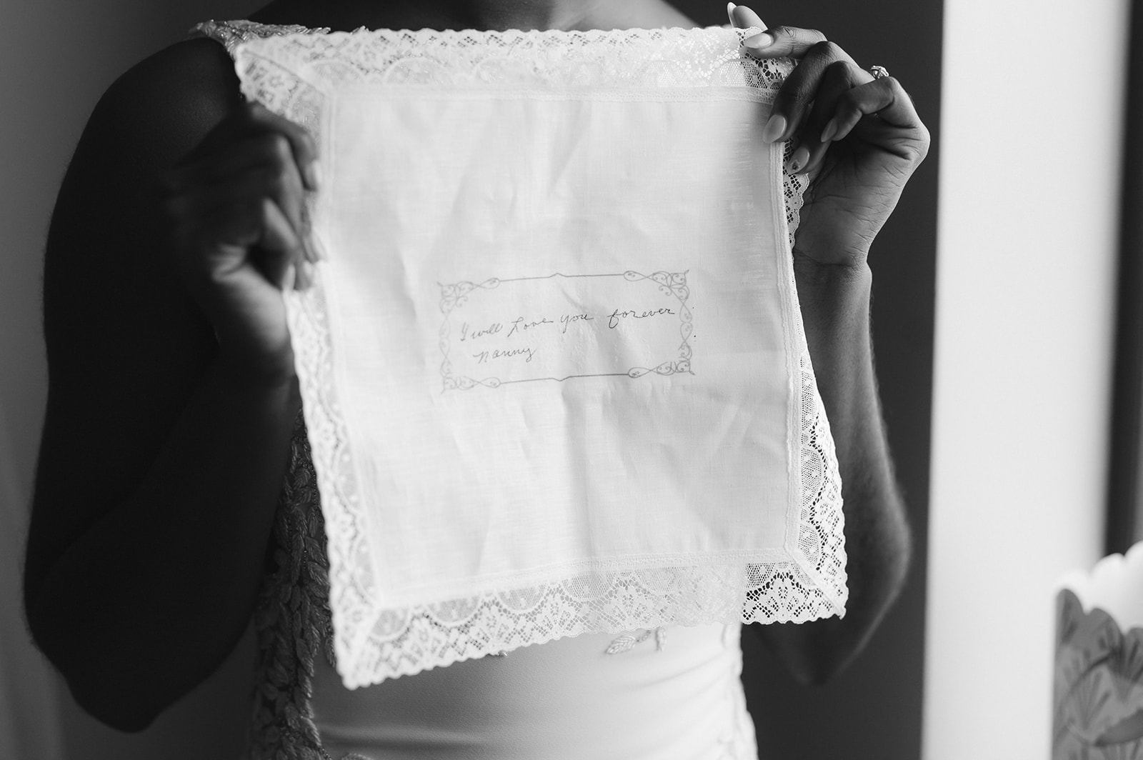 A close-up of the bride's grandmother's handwriting embroidered on a handkerchief. 