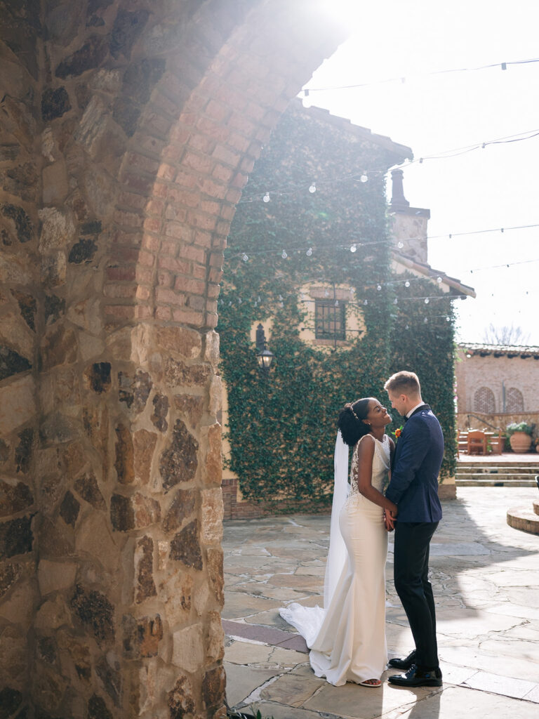 Bride and groom portraits against the climbing ivy at Bella Collina.