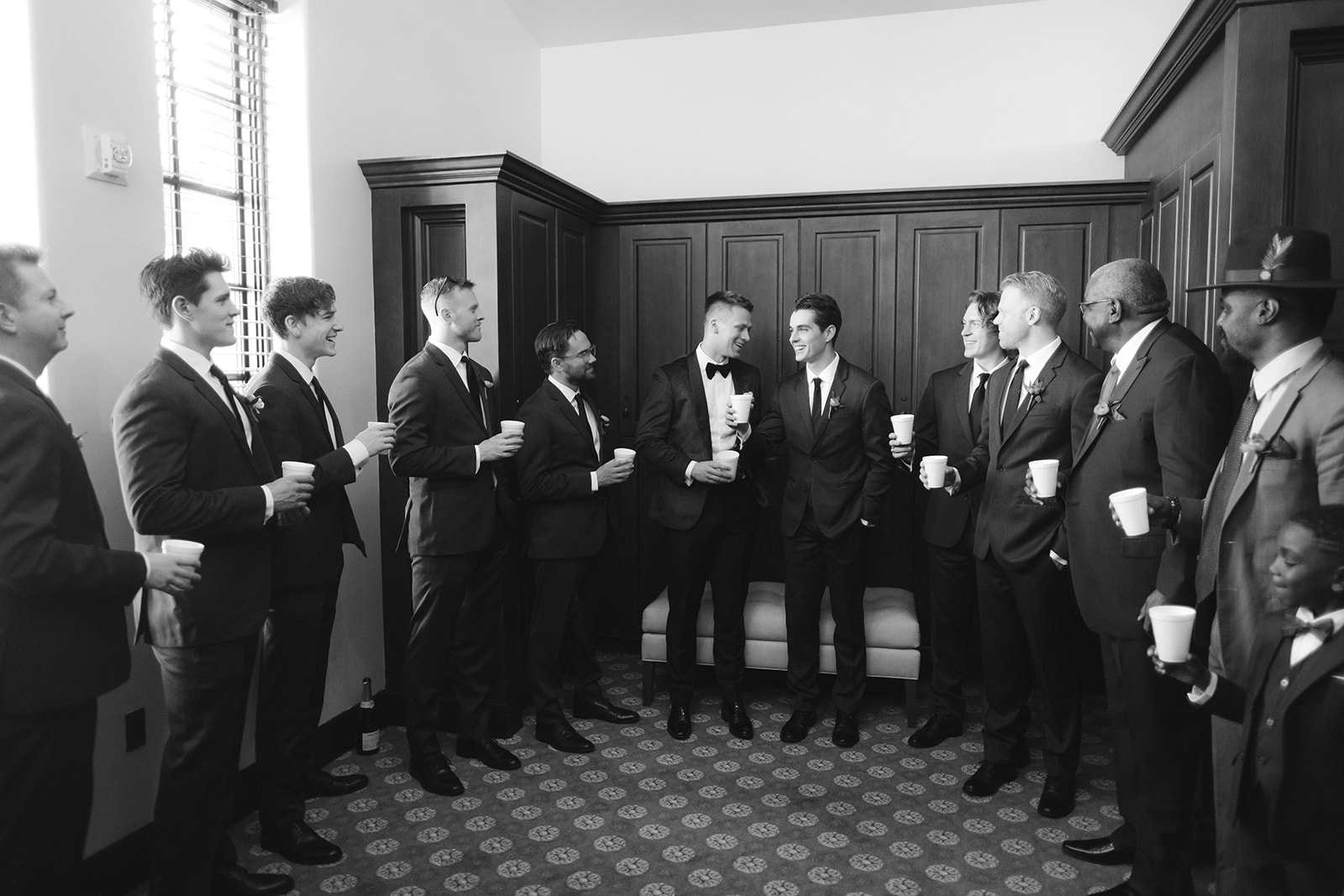 Groom sharing a toast with his groomsmen at Bella Collina.