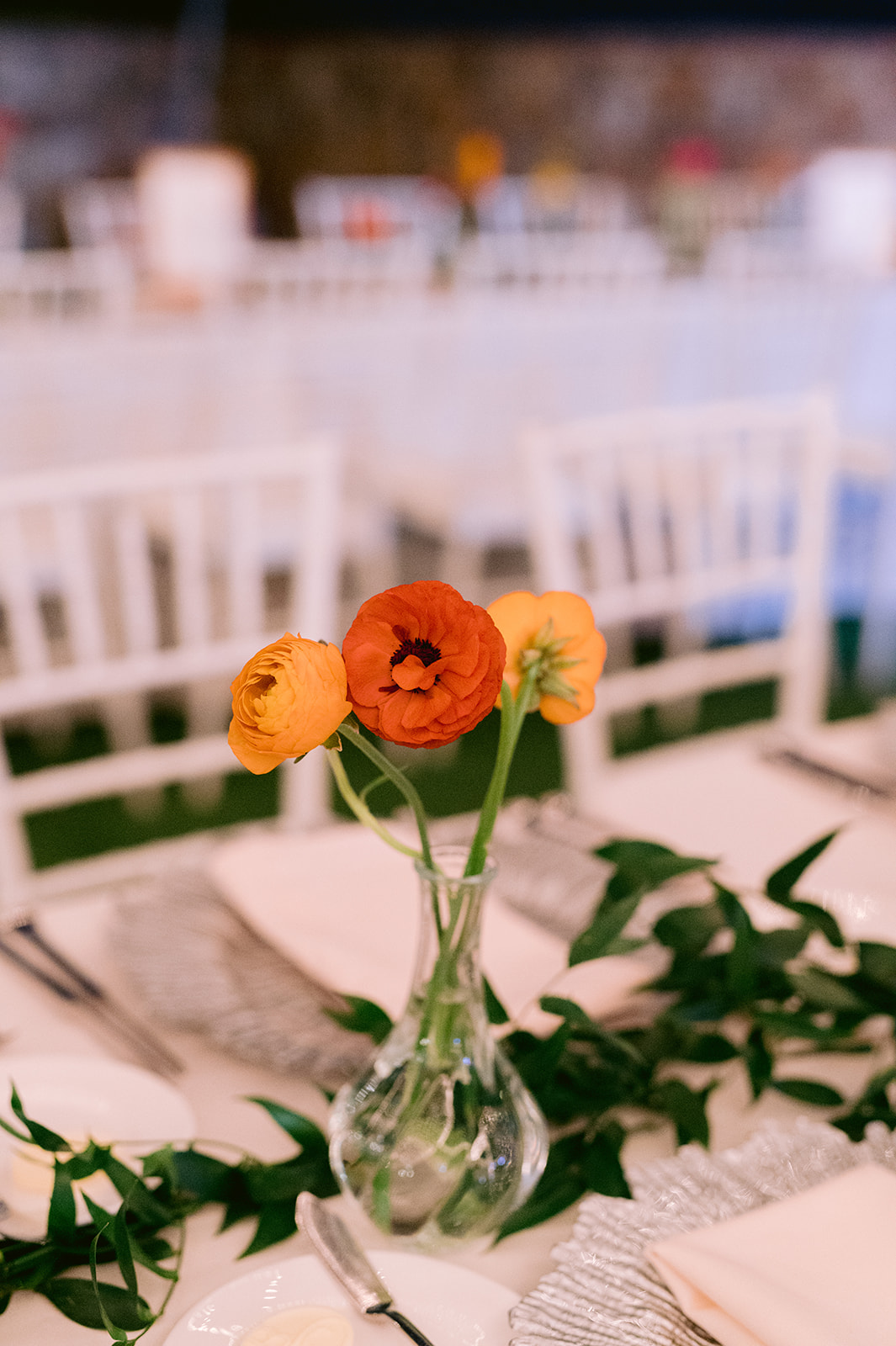 Wedding reception table centerpiece with yellow and orange poppies.