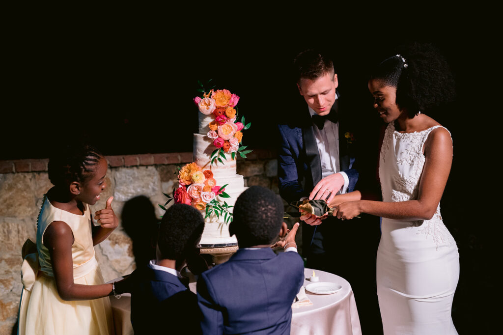 Bride and groom wedding reception cake cutting.