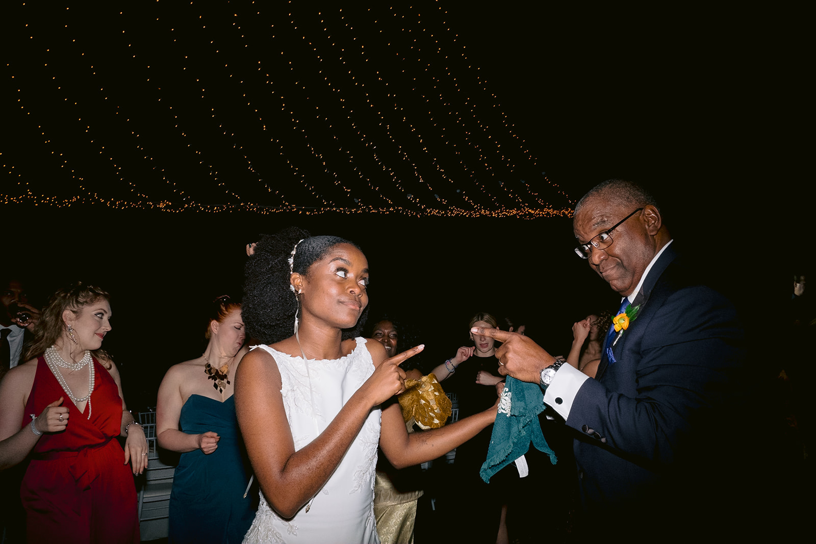 Candid moment of a bride and her dad during the reception.