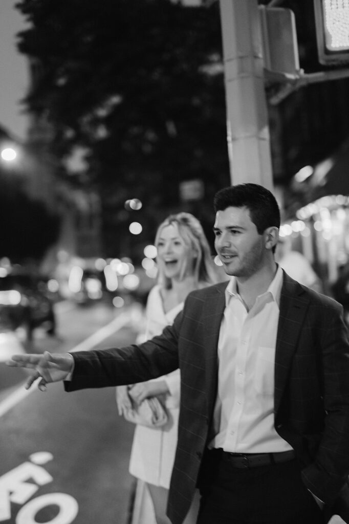 Couple catching a cab during their NYC engagement session.