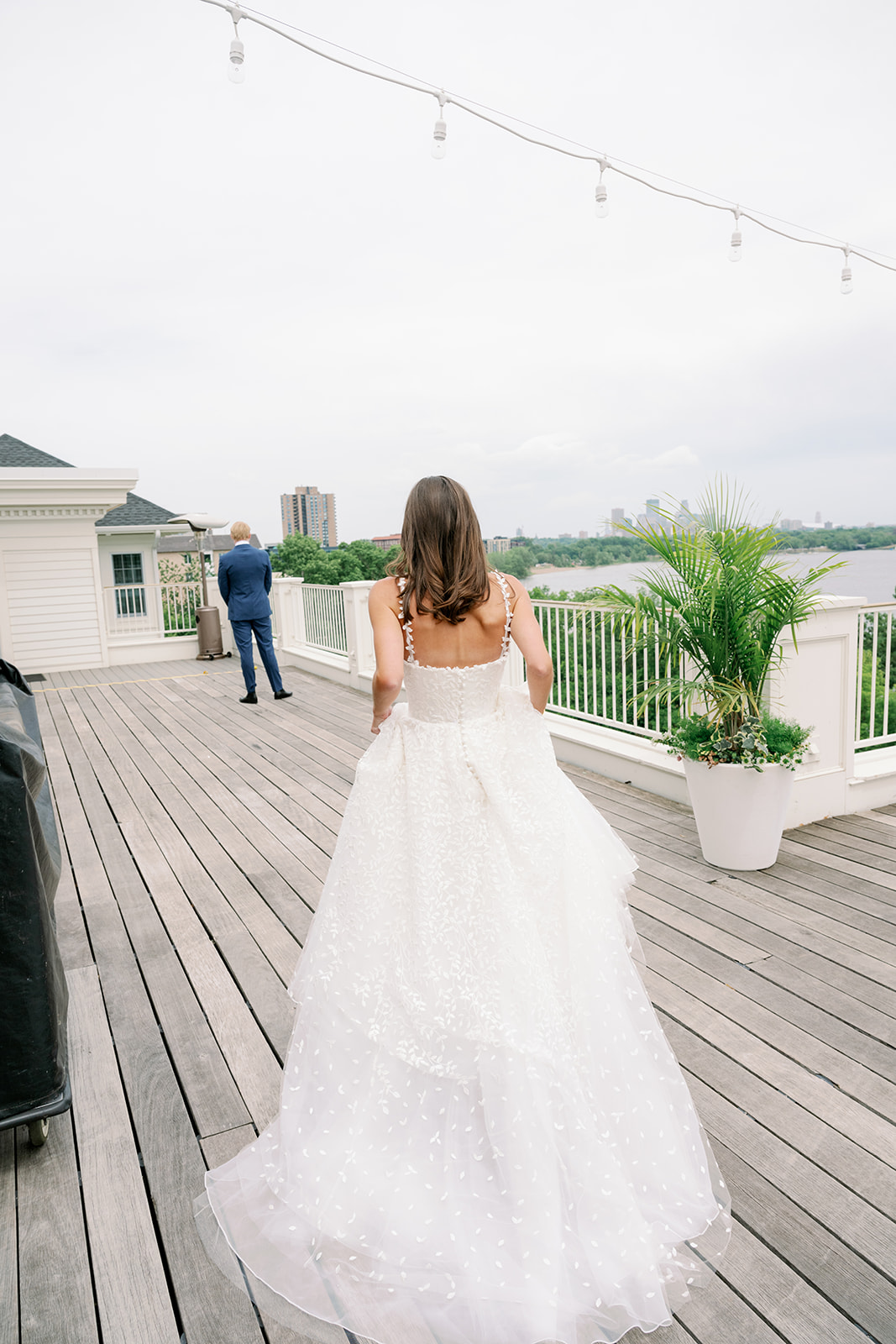 Carly and Todd First Look on the balcony overlooking Lake Minikahda and downtown Minneapolis. 