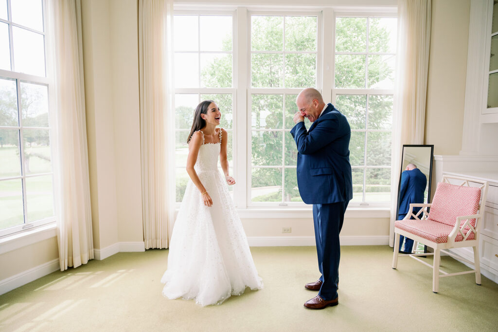 Carly and her dad sharing an emotional first look moment in the bridal suite at Minikahda Club.