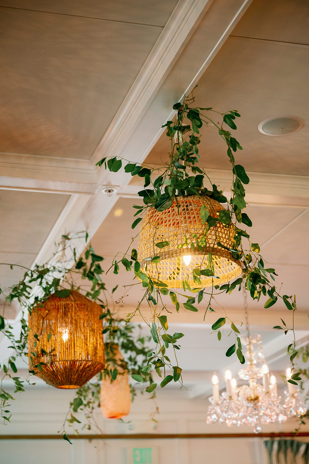 Boho hanging lanterns with greenery wedding decor.