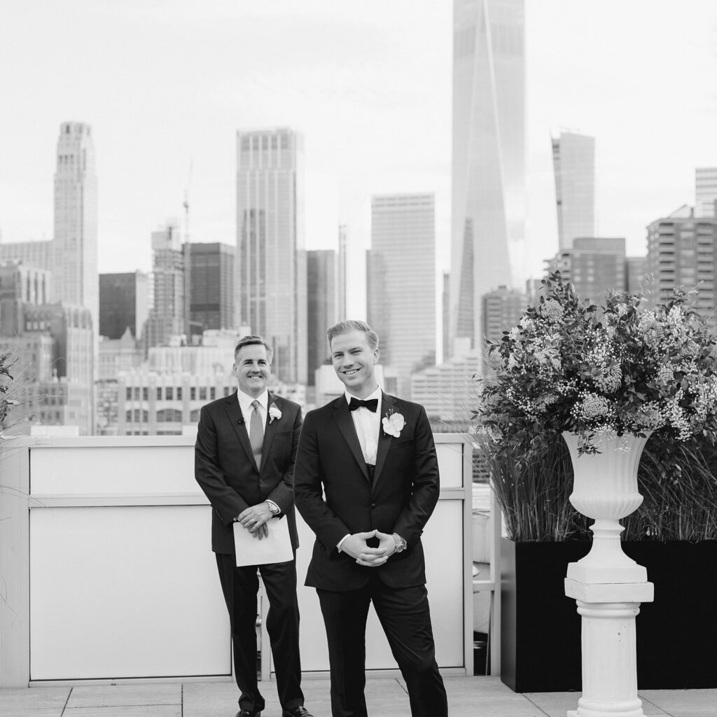 Tribeca Rooftop wedding ceremony captures the joy as he watches his bride walk down the aisle, city views in the background.