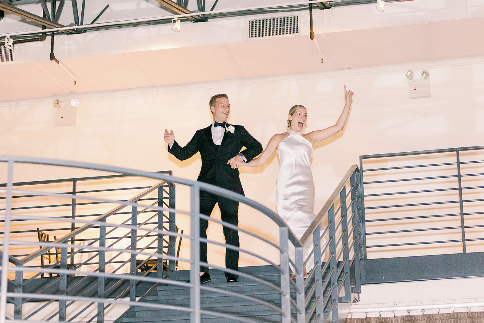 Tribeca Rooftop wedding reception - Bride and groom make a grand entrance on the balcony, kicking off an unforgettable celebration.
