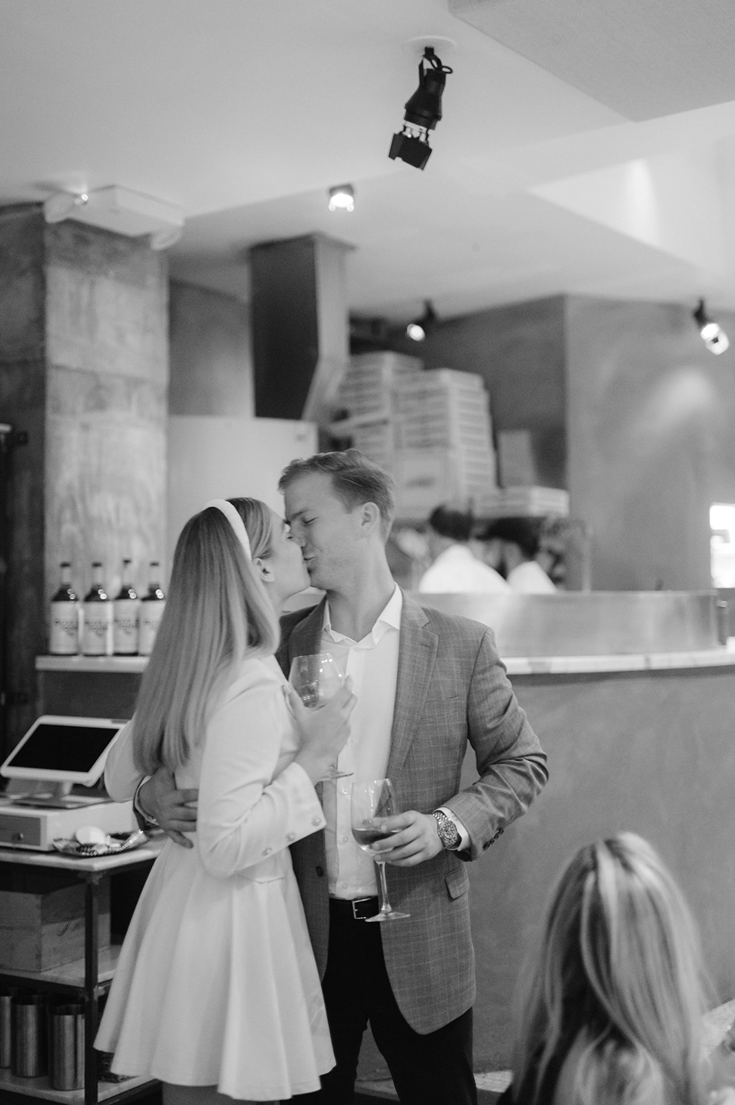 Bride and groom share a tender kiss, captured candidly at Coco Pazzaria NYC's wedding welcome party and rehearsal dinner.