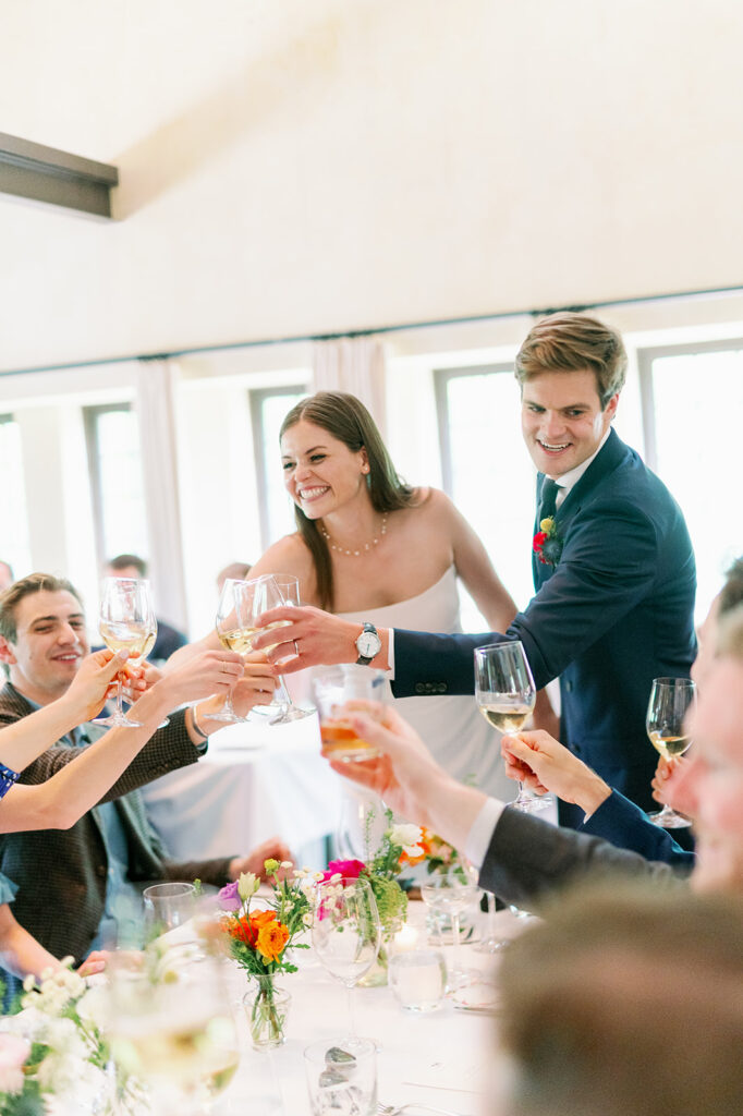 Couple sharing a toast with their wedding guests at Blue Hill at Stone Barns. 