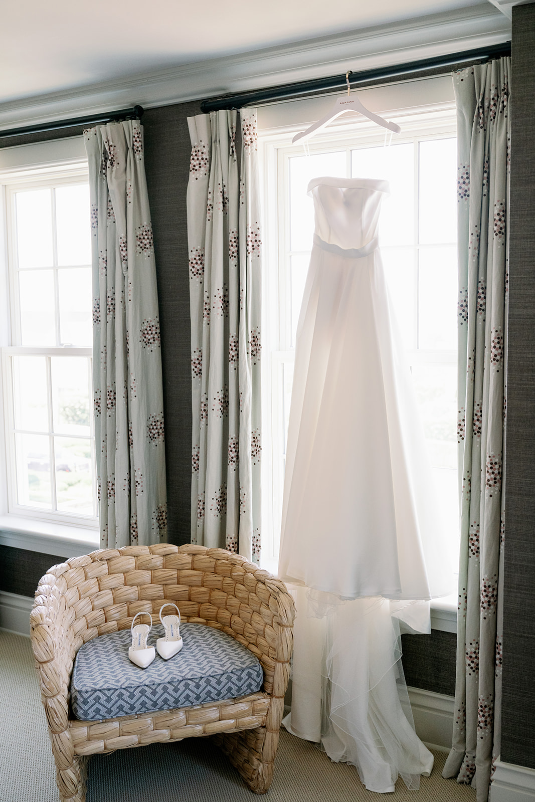 The Bride's wedding gown, "The Viv" hanging from a hotel window at Ocean House. 