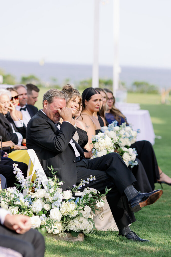 Guests showing emotion during an outdoor wedding ceremony at Ocean House in Rhode Island. 