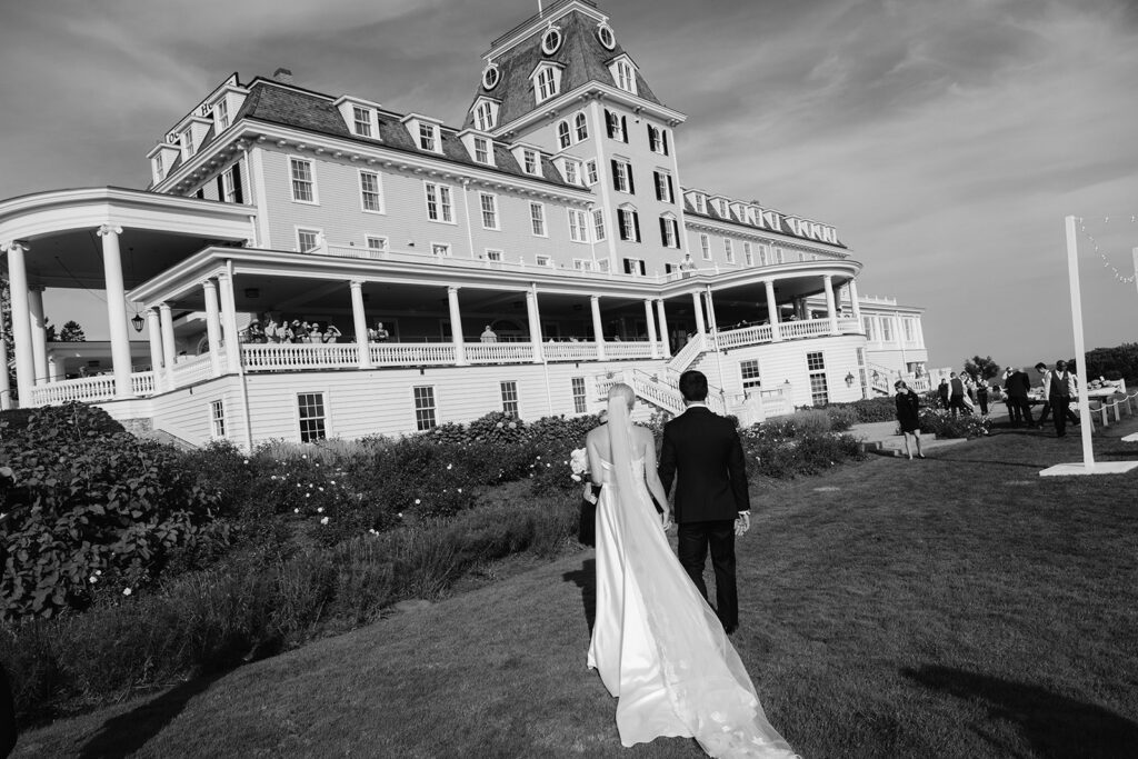 Bride and groom walking towards their venue Ocean House in Rhode Island.