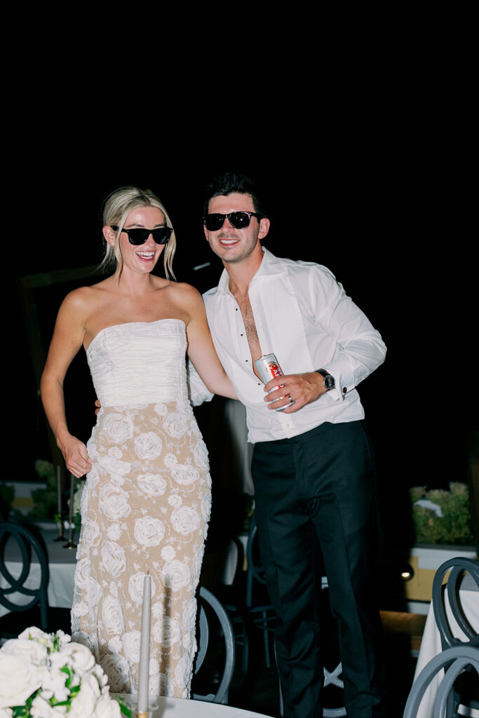 Direct flash candid portrait of a bride and groom wearing sunglasses during the reception dance party. 