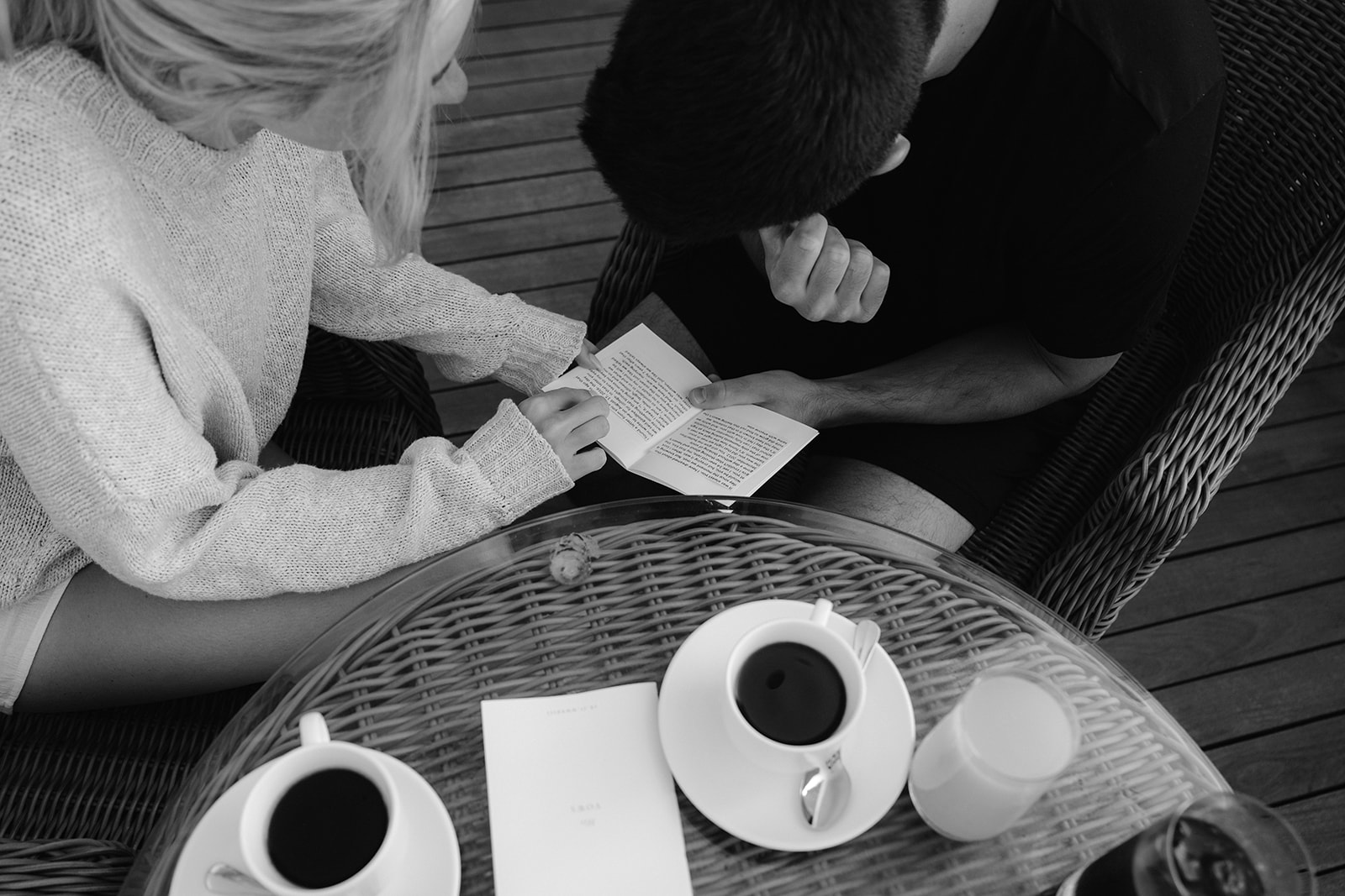Emotional cinematic capture of the bride and groom privately reading their vows over coffee. 