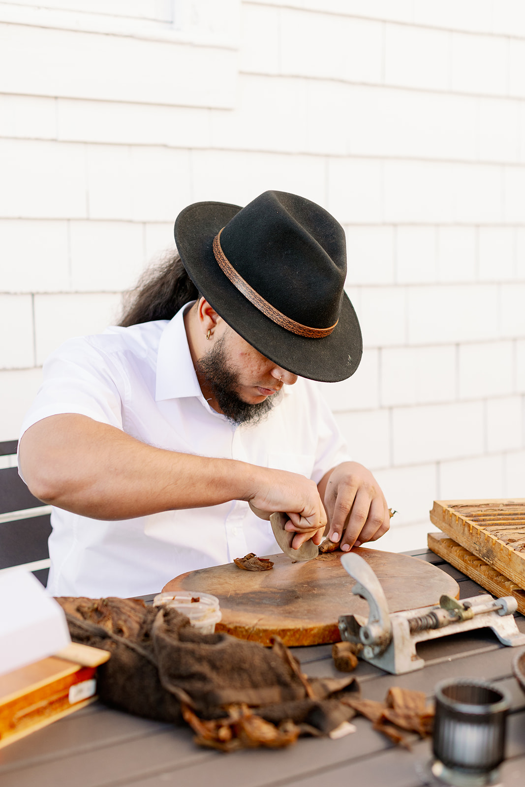Man making cigars at a Rhode Island wedding welcome party.