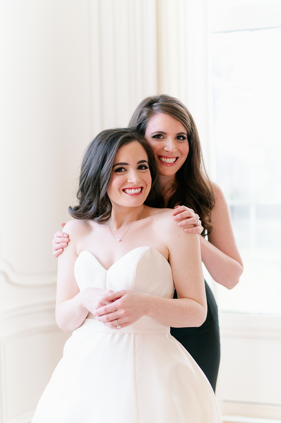Bride and sister sharing a posed moment at Pine Hollow Country Club.