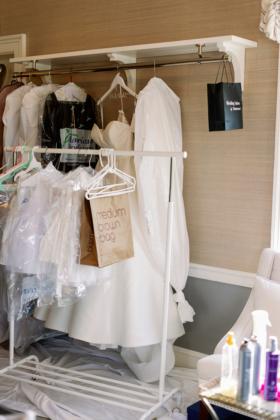 Bridal gowns and bridesmaid dresses hanging in the bridal suite at Pine Hollow Country Club. 