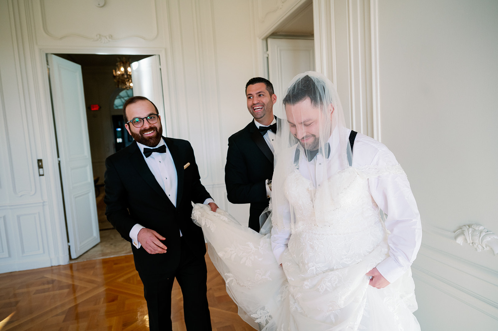 Best man wearing a wedding dress for a surprise "first look" with the groom.