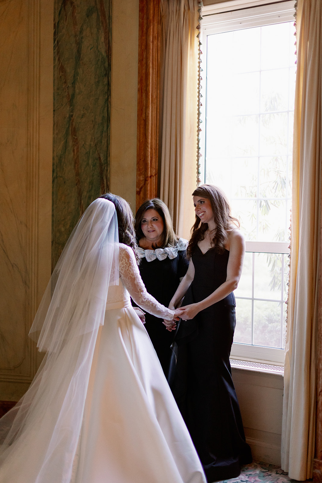 Bride sharing a candid moment with her mom and sister at Pine Hollow Country Club.