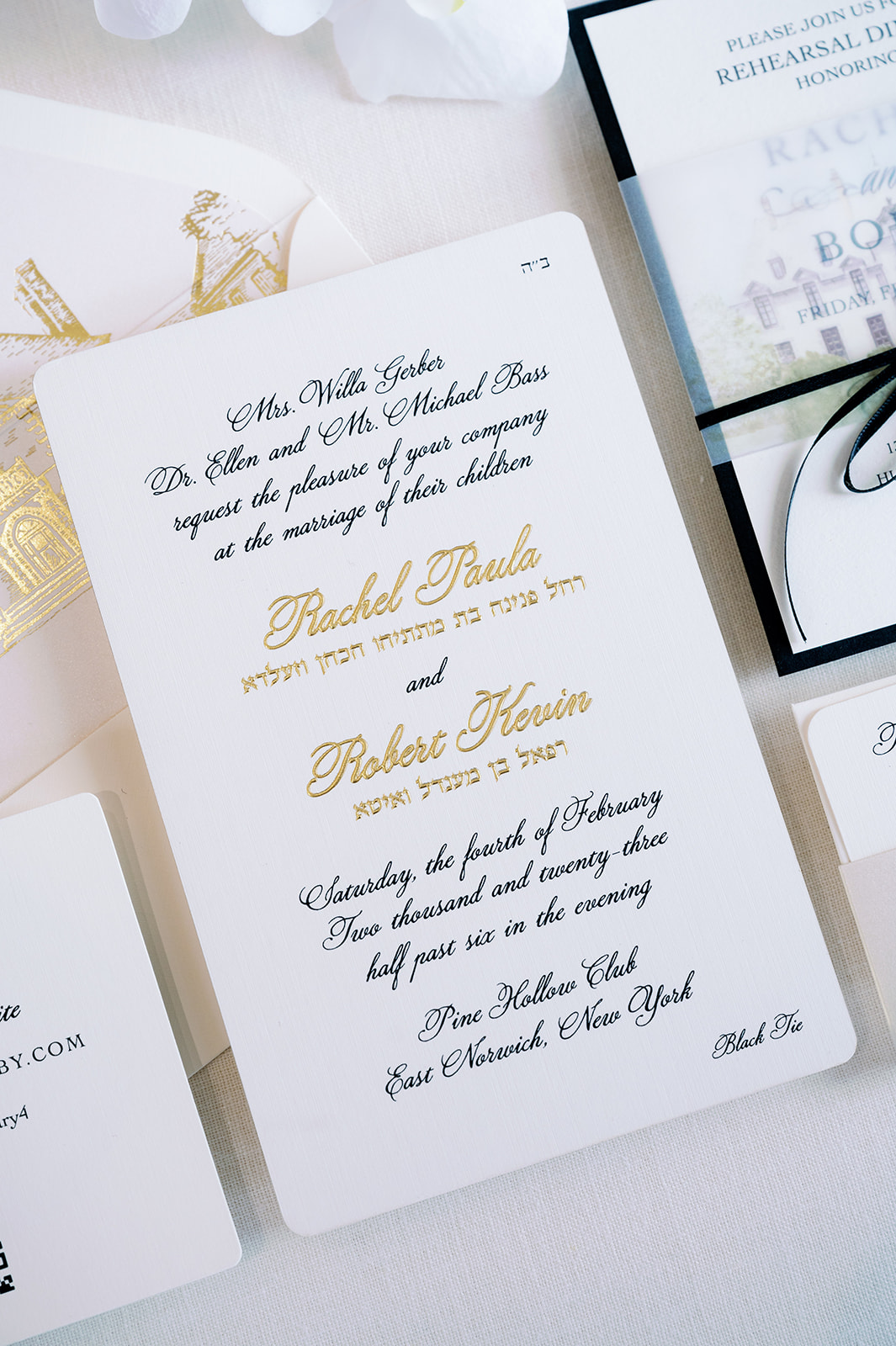 Elegant white and gold wedding invitation.