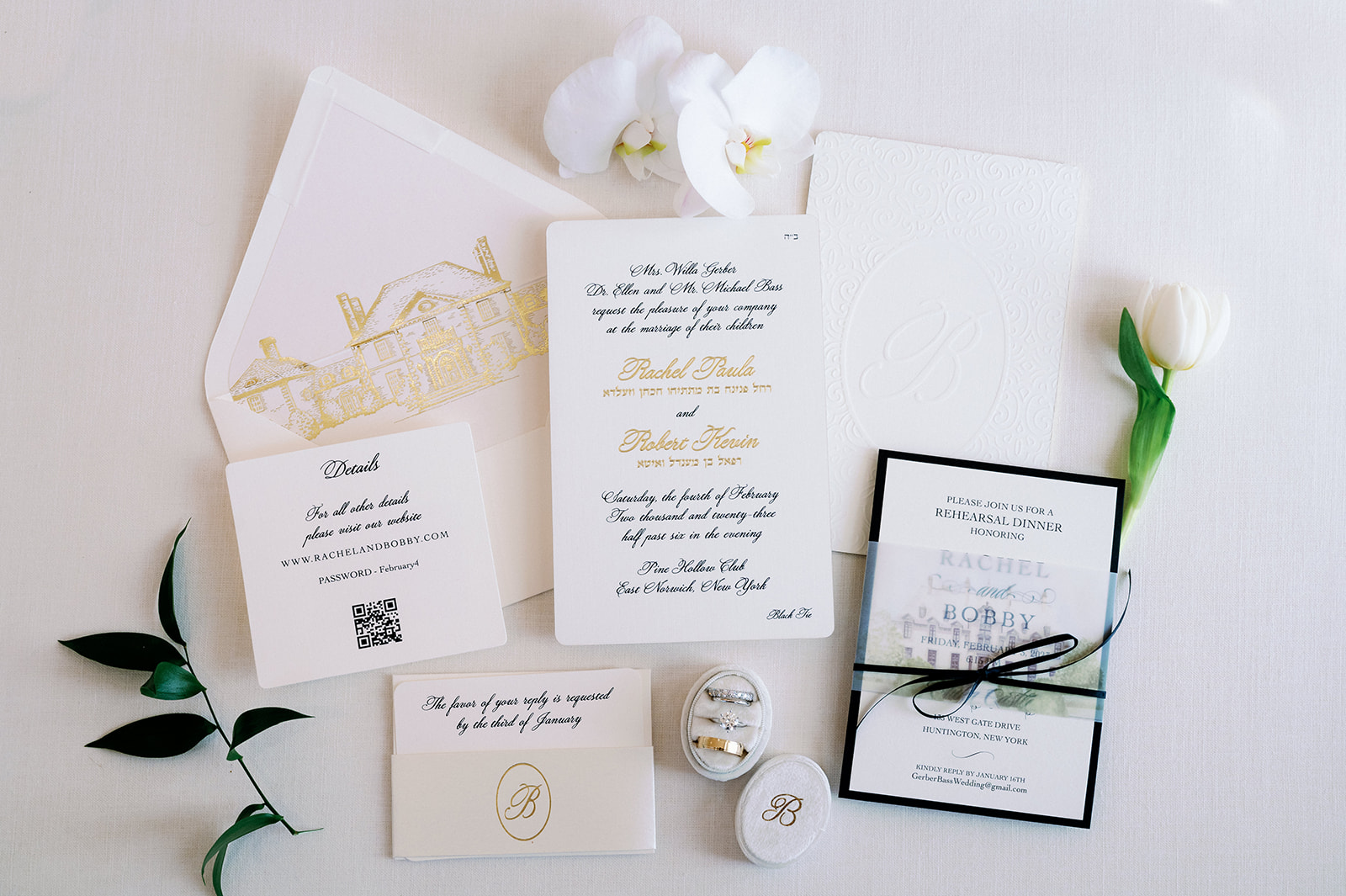 Elegant white and gold wedding invitation detail flat lay.