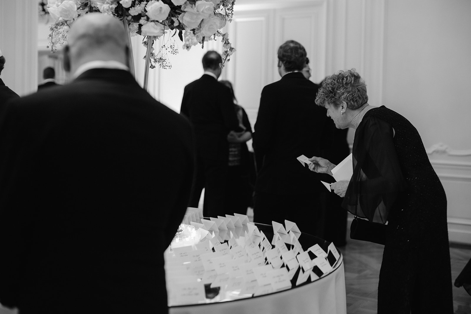 Wedding guests finding their name cards candid photo. 