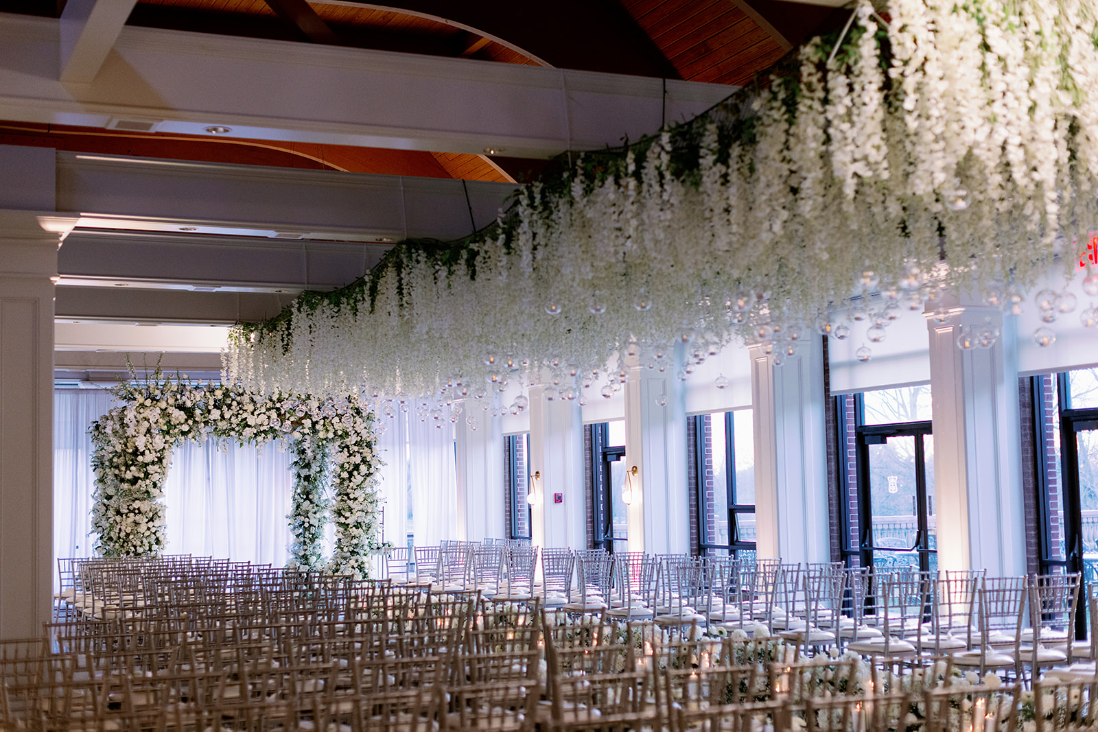 Wide view angle of a luxury white floral wedding ceremony at Pine Hollow Country Club.