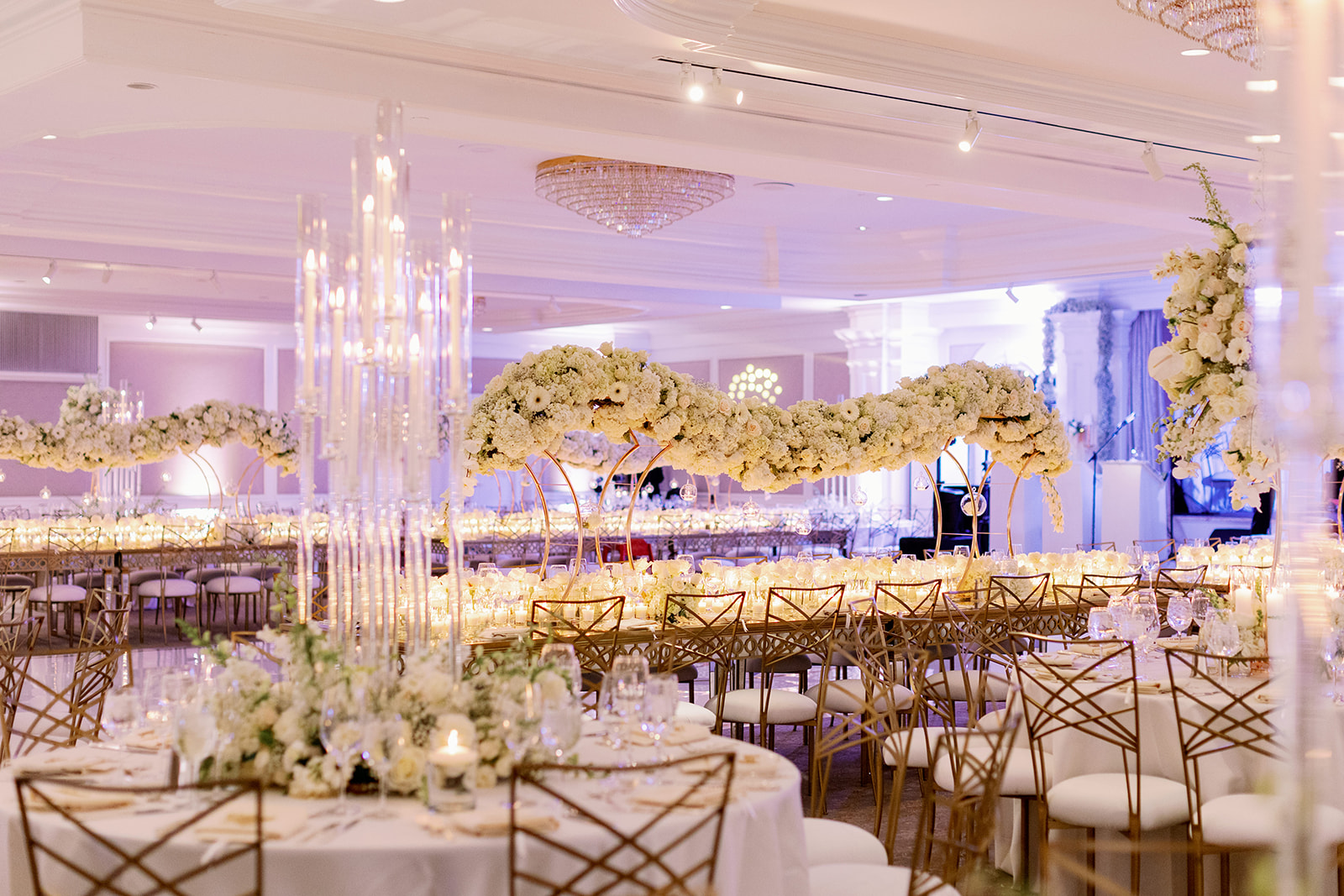 Glam wedding reception with continuous floating floral installation. 
