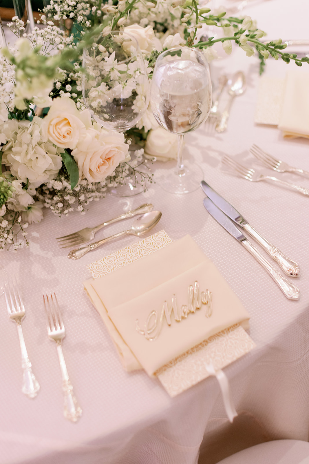 Wedding table setting with white florals. 