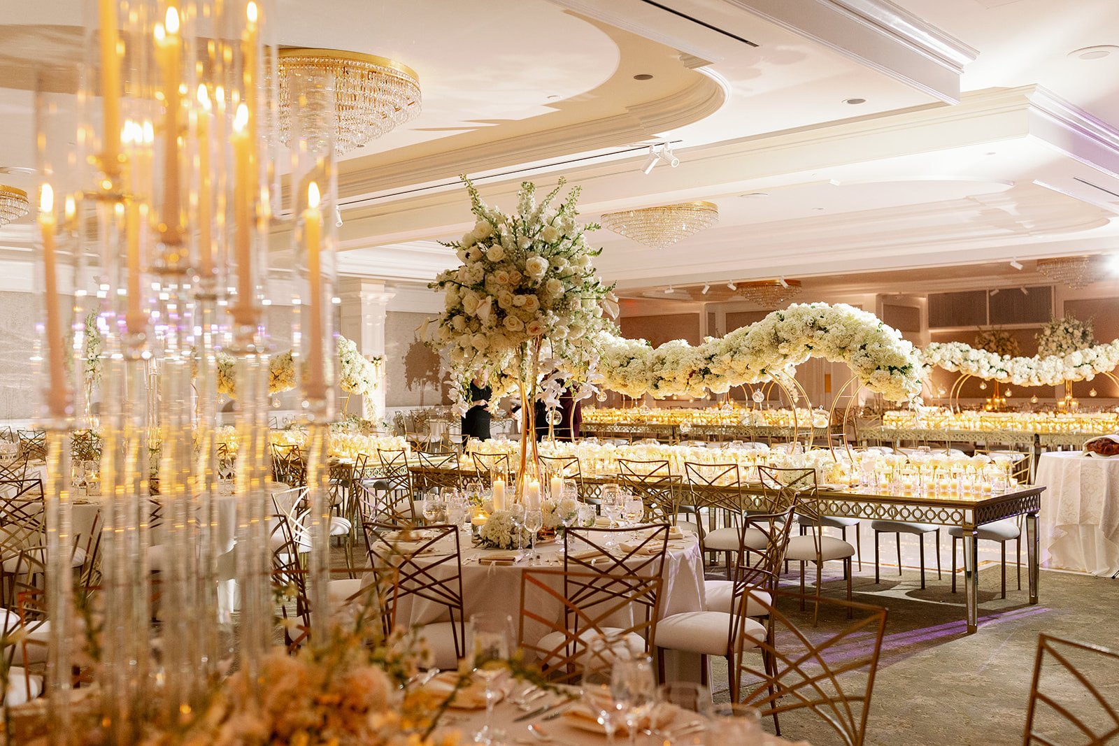 Luxury white floral filled indoor wedding reception at Pine Hollow Country Club.