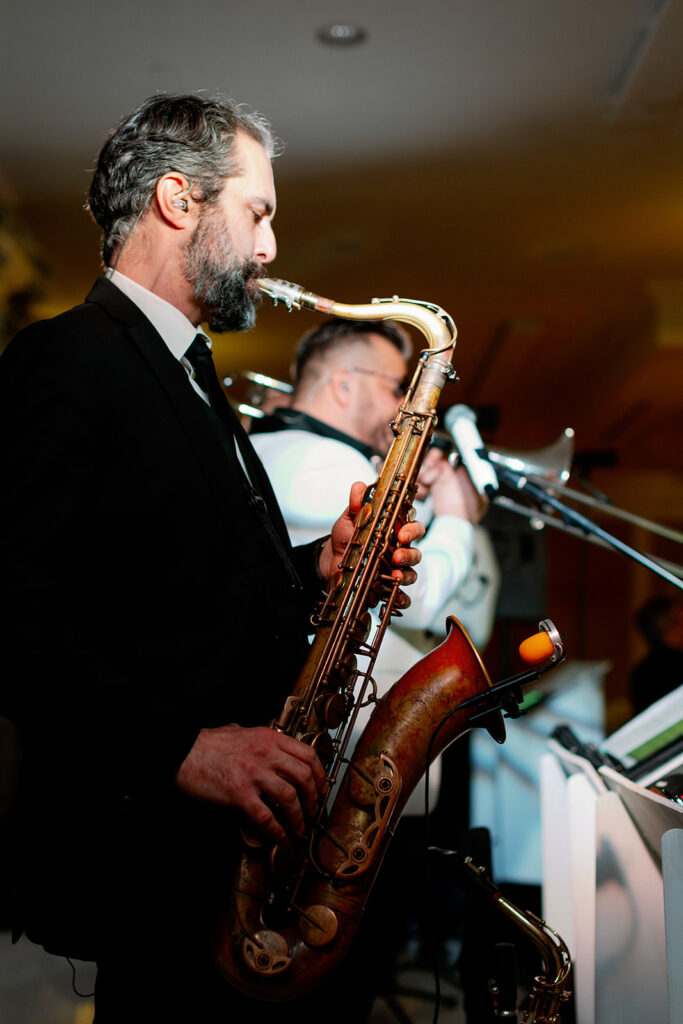 Man playing a saxaphone at a luxury wedding reception at Pine Hollow Country Club.