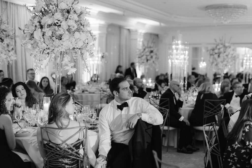 Guests listening to speeches at a Pine Hollow Country Club wedding reception.