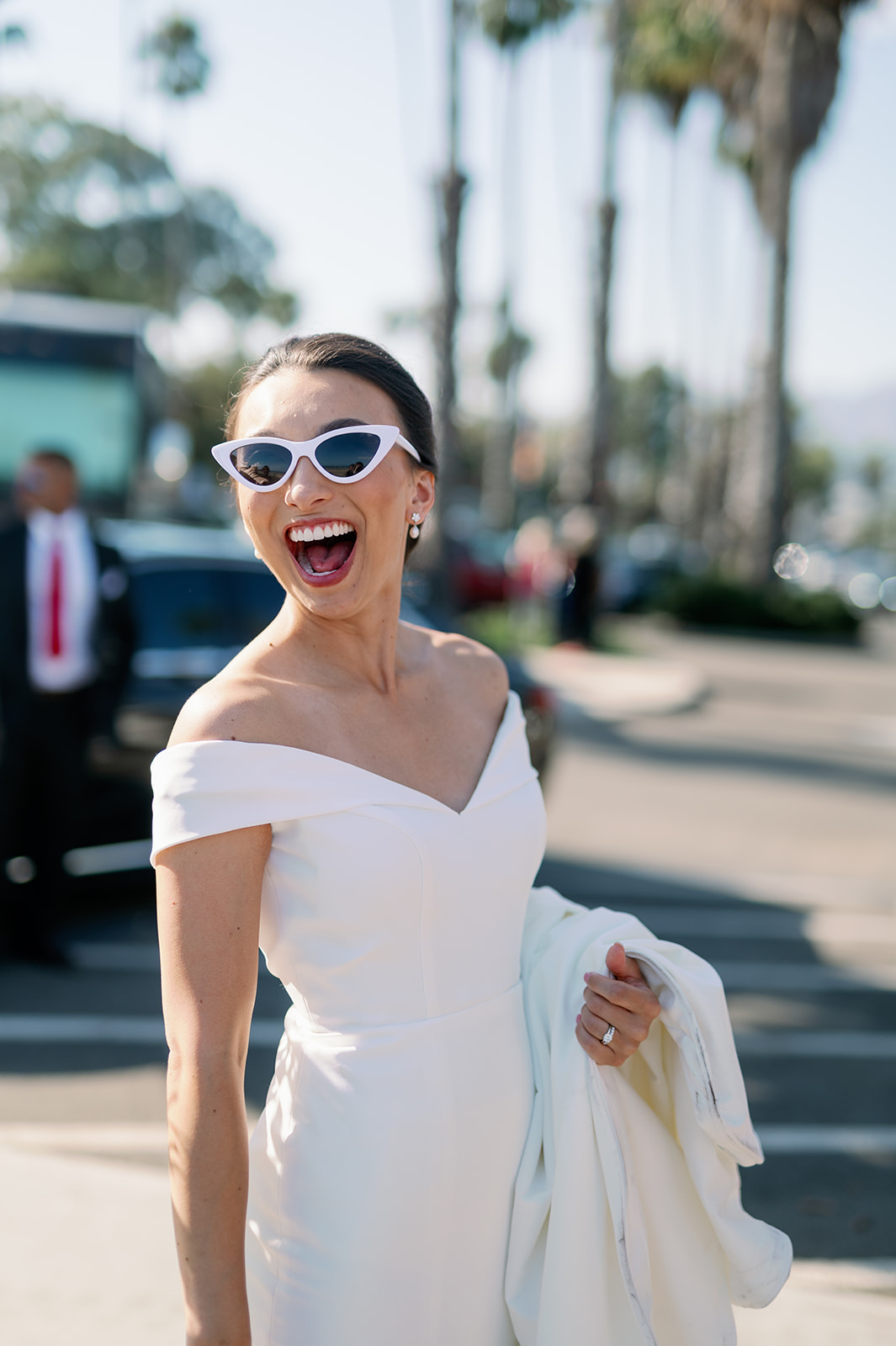California bride wearing sunglasses on her way to the beach.