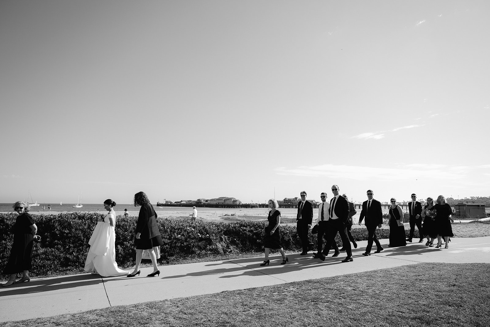 Wedding party walking to the beach after an intimate Santa Barbara Courthouse ceremony.