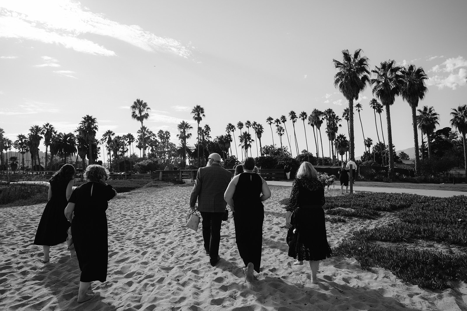 Wedding guests walking on the beach in Santa Barbara. 