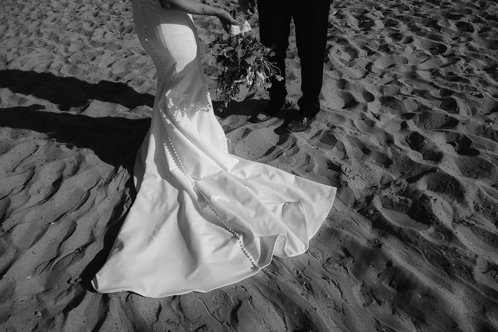 Fine art wedding dress detail shot on the beach. 