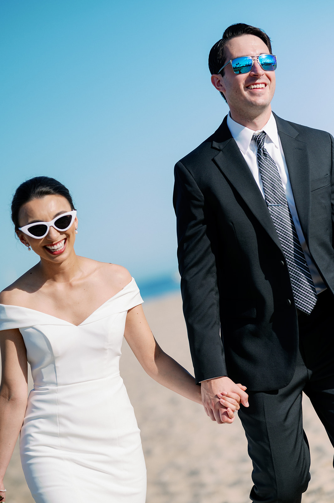 Santa Barbara, California bride and groom beach photos with sunglasses. 