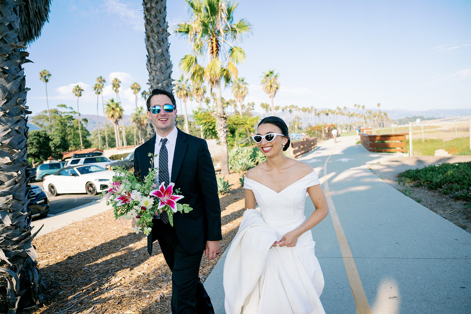 Bride and groom leaving the beach after portraits in Santa Barbara. 