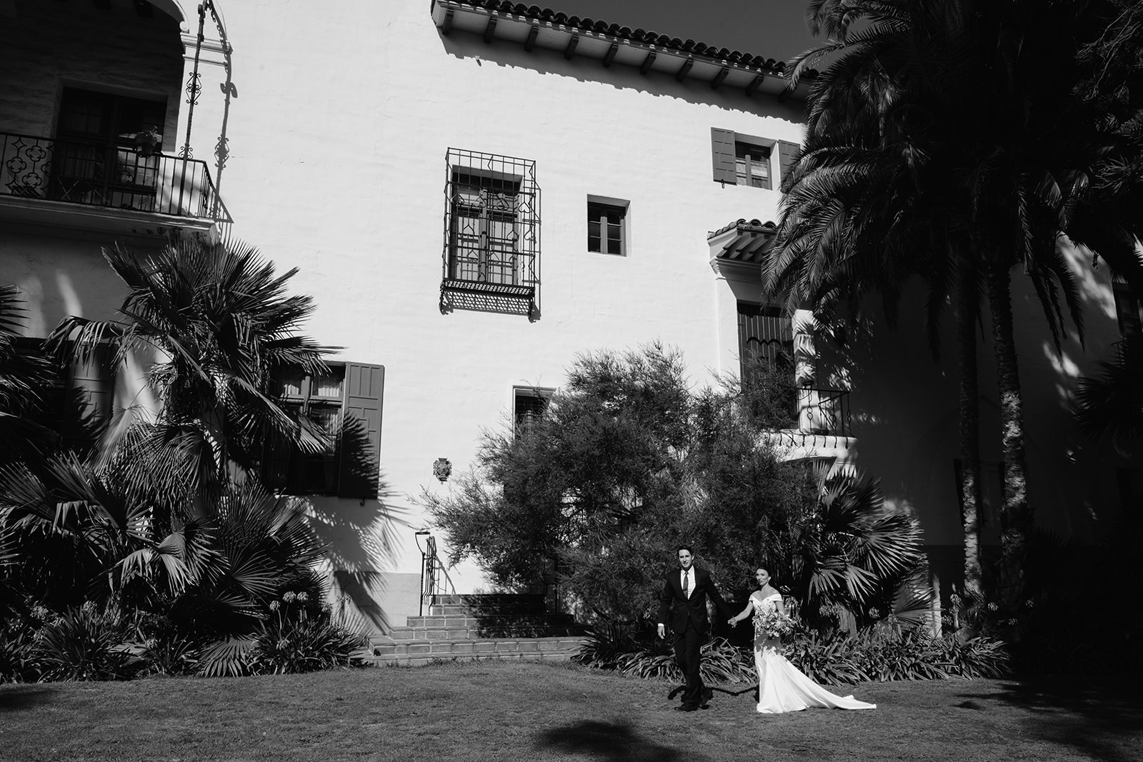 Bride and groom walking outside the Santa Barbara Courthouse.