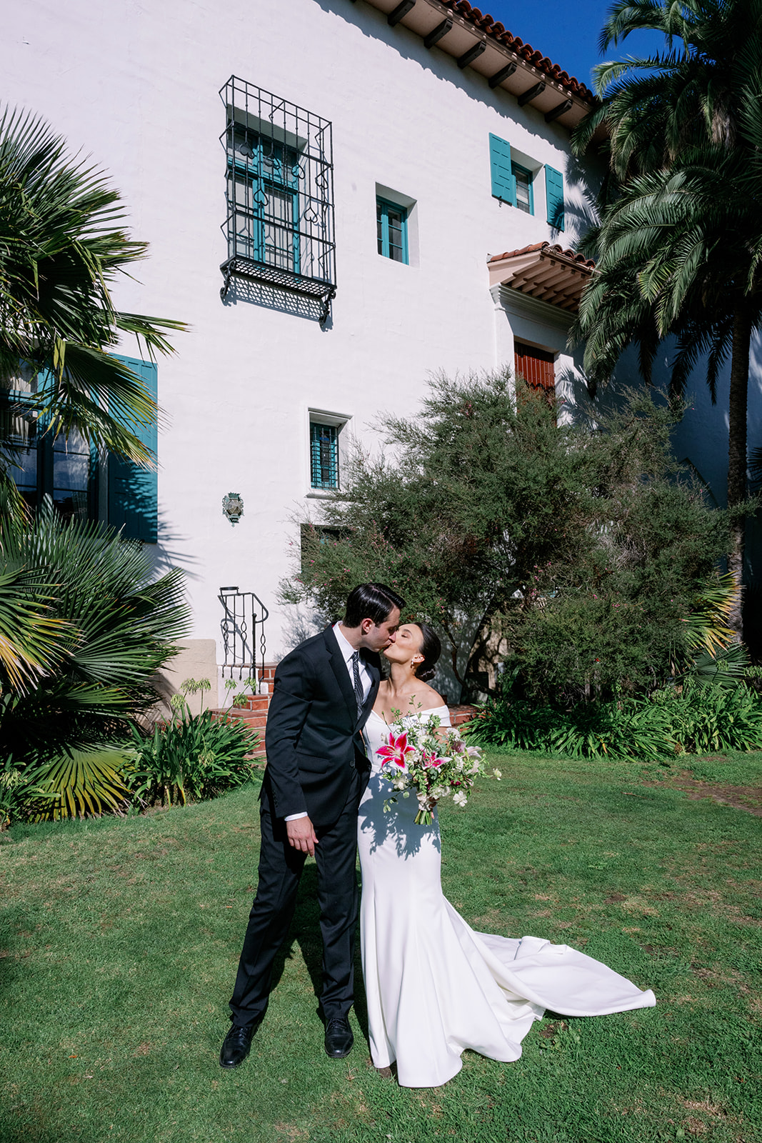 Bride and groom kissing in front of the Santa Barbara Courthouse.