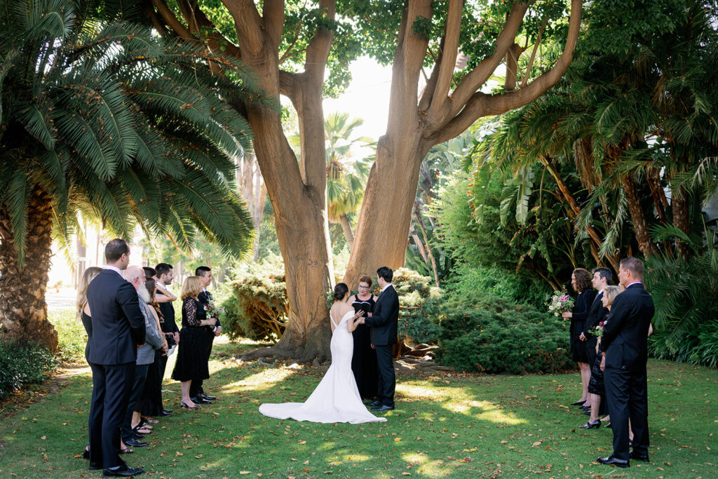 Intimate and sweet Santa Barbara Courthouse garden wedding ceremony under a large tree. 
